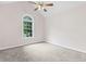 This bedroom offers a large arched window, carpet flooring, and ceiling fan at 775 Tribble Cove Dr, Lawrenceville, GA 30045