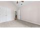 Bedroom features a double door closet, carpet flooring, and ceiling fan at 775 Tribble Cove Dr, Lawrenceville, GA 30045