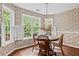 Bright breakfast nook with ample natural light, a cozy dining table, and a view of the surrounding greenery at 775 Tribble Cove Dr, Lawrenceville, GA 30045