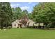 Stunning single-story home with a lush green lawn and mature trees at 775 Tribble Cove Dr, Lawrenceville, GA 30045