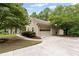 Spacious garage with a concrete driveway and well-manicured landscaping at 775 Tribble Cove Dr, Lawrenceville, GA 30045
