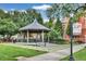 Charming gazebo in a park setting with historic brick buildings in the backdrop at 775 Tribble Cove Dr, Lawrenceville, GA 30045