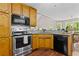 Efficient kitchen with stainless steel appliances, wooden cabinets, and granite countertops, designed for convenience and style at 775 Tribble Cove Dr, Lawrenceville, GA 30045