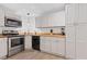 Cozy kitchen featuring white cabinets, wood countertops, and stainless steel appliances at 775 Tribble Cove Dr, Lawrenceville, GA 30045