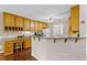 Charming kitchen with wooden cabinets, granite countertops, and breakfast bar, perfect for casual dining and entertaining at 775 Tribble Cove Dr, Lawrenceville, GA 30045