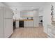 This kitchen is well-appointed with bright white cabinetry, black appliances, recessed lighting and wood-look floors at 775 Tribble Cove Dr, Lawrenceville, GA 30045