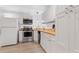 Bright and modern kitchen featuring stainless steel appliances, recessed lights and crisp white cabinetry at 775 Tribble Cove Dr, Lawrenceville, GA 30045