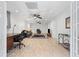 Open-concept living room with neutral color palette, recessed lights, wood-look floors, work space and french doors at 775 Tribble Cove Dr, Lawrenceville, GA 30045