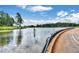 Scenic pond view with a walking path and lush green trees at 775 Tribble Cove Dr, Lawrenceville, GA 30045
