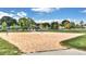 Outdoor sand volleyball court surrounded by trees and green grass at 775 Tribble Cove Dr, Lawrenceville, GA 30045