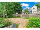 A well-maintained backyard featuring a stone patio, lush greenery, and a garden bed for urban gardening at 176 Ormond Se St, Atlanta, GA 30315