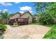 A spacious backyard with a stone patio, wooden deck, and lush landscaping surrounding the property at 176 Ormond Se St, Atlanta, GA 30315