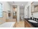 Bathroom showcases vanity with dark counter, soaking tub, and tiled glass enclosed shower at 176 Ormond Se St, Atlanta, GA 30315