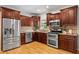 Spacious kitchen featuring stainless steel appliances, wooden cabinets, granite countertops, and hardwood floors at 176 Ormond Se St, Atlanta, GA 30315