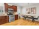Well-lit kitchen with stainless steel appliances, wood cabinets, and adjacent dining area at 176 Ormond Se St, Atlanta, GA 30315
