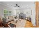 Bright living room with hardwood floors, fireplace, ceiling fan, and modern furnishings at 176 Ormond Se St, Atlanta, GA 30315