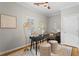 Office with hardwood floors, modern desk, patterned rug, and plantation shutters at 176 Ormond Se St, Atlanta, GA 30315