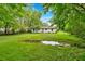 View of the home's backyard featuring a spacious lawn and mature trees around the perimeter at 2326 Brackett Sw St, Marietta, GA 30060