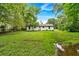 View of the home's backyard featuring a spacious lawn and mature trees around the perimeter at 2326 Brackett Sw St, Marietta, GA 30060