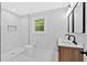 Modern bathroom features a double vanity, marble tile shower, and sleek fixtures at 2326 Brackett Sw St, Marietta, GA 30060