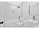 Modern bathroom features white marble style tile, vanity and gold faucet at 2326 Brackett Sw St, Marietta, GA 30060