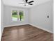 This modern bedroom has hardwood flooring and an airy feel with a backyard view at 2326 Brackett Sw St, Marietta, GA 30060