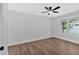Bright bedroom features wooden floors, a ceiling fan and view of yard at 2326 Brackett Sw St, Marietta, GA 30060