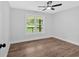 Bright and airy bedroom features wooden floors and a ceiling fan, with a view outside at 2326 Brackett Sw St, Marietta, GA 30060