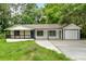 Charming home with a covered porch, manicured lawn, and attached garage at 2326 Brackett Sw St, Marietta, GA 30060