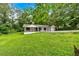 Exterior of lovely home featuring an expansive green yard and mature trees at 2326 Brackett Sw St, Marietta, GA 30060