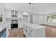 Bright kitchen features an island, stainless steel appliances, white cabinets and flooring at 2326 Brackett Sw St, Marietta, GA 30060