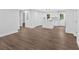 Open-concept living space featuring laminate flooring, a kitchen island, and white cabinets at 2326 Brackett Sw St, Marietta, GA 30060