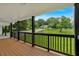 An inviting covered porch with wood flooring and dark pillars showcases front yard views at 2326 Brackett Sw St, Marietta, GA 30060