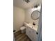 Bathroom with a round mirror and modern fixtures at 4701 Flat Shoals Rd # 48B, Union City, GA 30291