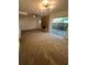 Open living room with a brick fireplace and sliding glass doors to the outside at 4701 Flat Shoals Rd # 48B, Union City, GA 30291