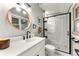 Modern bathroom featuring black fixtures, subway tile shower, and circular mirror at 611 Pickett Se St, Atlanta, GA 30316
