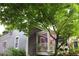Side view of a two-story home with lilac exterior paint and lush greenery surrounding the property at 611 Pickett Se St, Atlanta, GA 30316