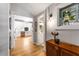 Hallway view to kitchen and bathroom with hardwood floors and decorative stained glass window at 611 Pickett Se St, Atlanta, GA 30316