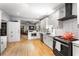 Bright kitchen with stainless appliances, white cabinetry, and hardwood floors at 611 Pickett Se St, Atlanta, GA 30316