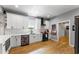 Contemporary kitchen with white cabinets, hardwood floors, and stainless steel appliances at 611 Pickett Se St, Atlanta, GA 30316