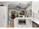 Open-concept kitchen with white cabinets, stainless steel appliances, and a view into the living room at 611 Pickett Se St, Atlanta, GA 30316