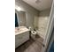 A view of a well-lit bathroom featuring a vanity, toilet, and shower-tub combo with gray walls at 5388 Robertson Path, Lithonia, GA 30038
