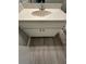 A view of a bathroom vanity with a white countertop and wood look floor at 5388 Robertson Path, Lithonia, GA 30038