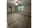An airy bedroom with gray walls, ceiling fan, crown molding, and wood-look floors with natural light at 5388 Robertson Path, Lithonia, GA 30038