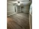 An airy bedroom with gray walls, ceiling fan, crown molding, and wood-look floors at 5388 Robertson Path, Lithonia, GA 30038