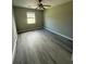Bedroom with updated flooring, ceiling fan and natural light from the window at 5388 Robertson Path, Lithonia, GA 30038