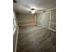 A view of a spacious bedroom with a ceiling fan, wood-look floors, and gray walls at 5388 Robertson Path, Lithonia, GA 30038