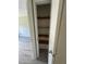 A view of the linen closet with open door and 3 shelves for home storage at 5388 Robertson Path, Lithonia, GA 30038