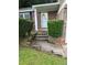 Inviting front entrance with brick accents, trimmed bushes, and a bright white front door at 5388 Robertson Path, Lithonia, GA 30038