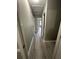 A long hallway with neutral walls and wood-look floors, leading to rooms with ample natural light at 5388 Robertson Path, Lithonia, GA 30038